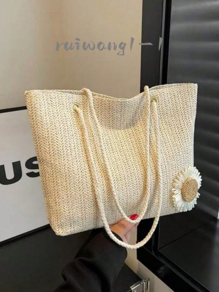 Borsa a mano intrecciata beige con decorazione floreale