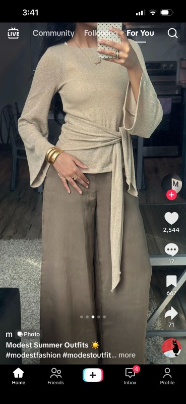 beige knitted top features long, wide sleeves and a side-tie detail.